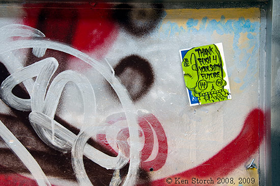 Grafitti and sticker in window of a failed store on the Lower East Side