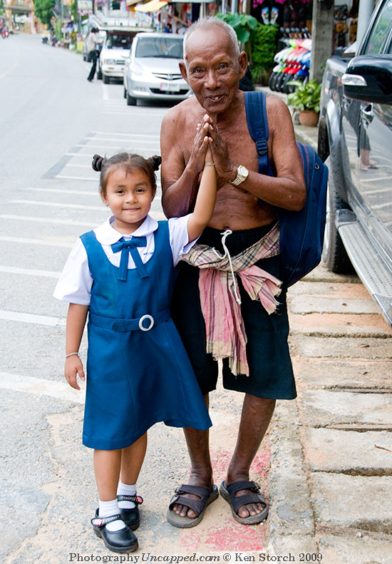 Girl and Old man at Karon Beach Phuket Thailand