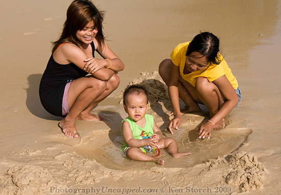 Pretty Young Women and Baby on Kata Beach Phuket Thailand