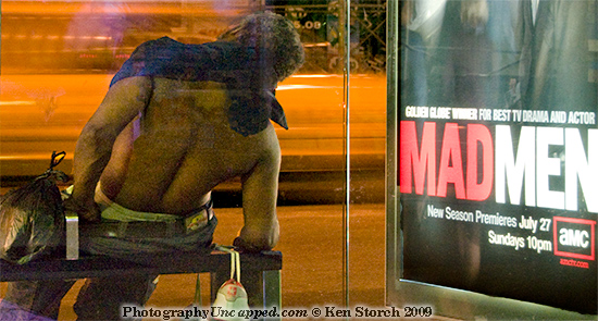 A close detail of the figure and Mad Men sign